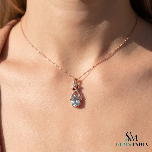 Oval Cut Aquamarine and Diamond Accent Twisted Swirl Pendant
