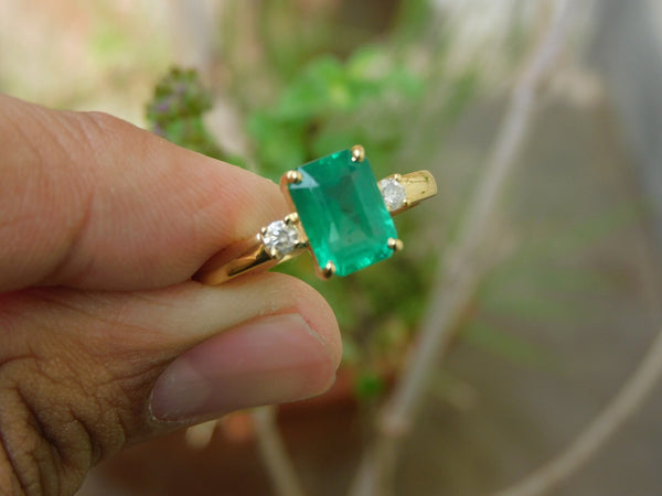 2.50 carat Elegant Emerald Cut Emerald Ring with Diamond Accents and 14k Gold Flat Band