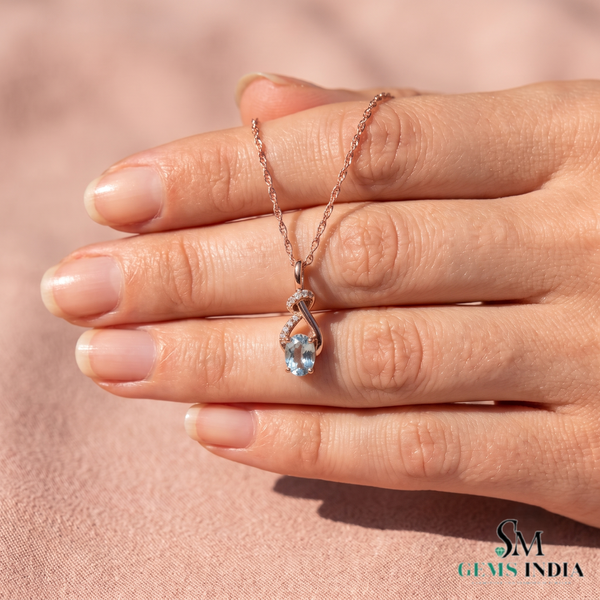 Oval Cut Aquamarine and Diamond Accent Twisted Swirl Pendant