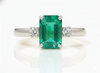 2.50 carat Elegant Emerald Cut Emerald Ring with Diamond Accents and 14k Gold Flat Band