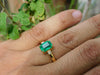 2.50 carat Elegant Emerald Cut Emerald Ring with Diamond Accents and 14k Gold Flat Band