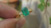 2.50 carat Elegant Emerald Cut Emerald Ring with Diamond Accents and 14k Gold Flat Band