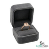Rose gold ring in a gray velvet box with 'Gems India' branding.