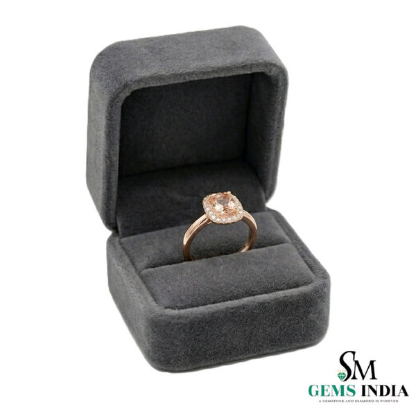 Rose gold ring in a gray velvet box with 'Gems India' branding.