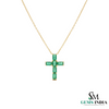 Gold necklace with a green gemstone cross pendant on a white background, branded 'SM Gems India'.