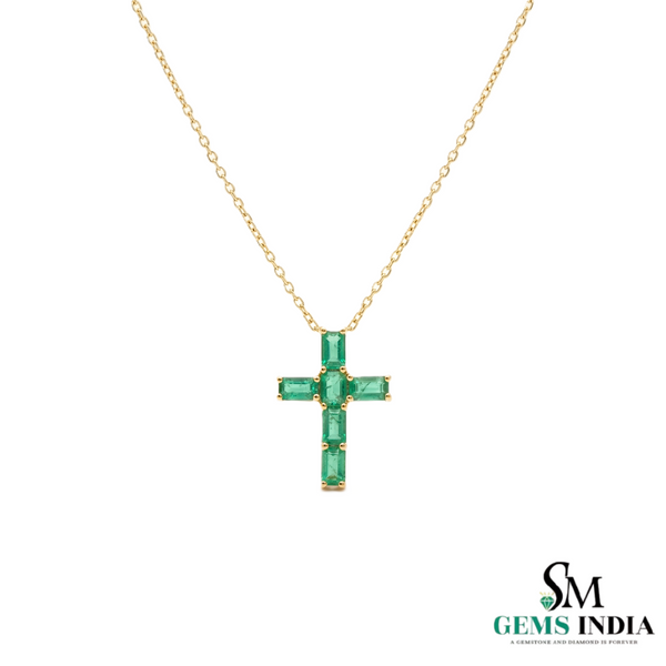 Gold necklace with a green gemstone cross pendant on a white background, branded 'SM Gems India'.