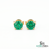 Gold earrings with green gemstones on a white background, branded 'SM Gems India'.