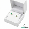 Green gemstone earrings in a white jewelry box with 'SM Gems India' branding.