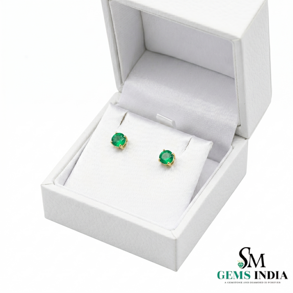 Green gemstone earrings in a white jewelry box with 'SM Gems India' branding.